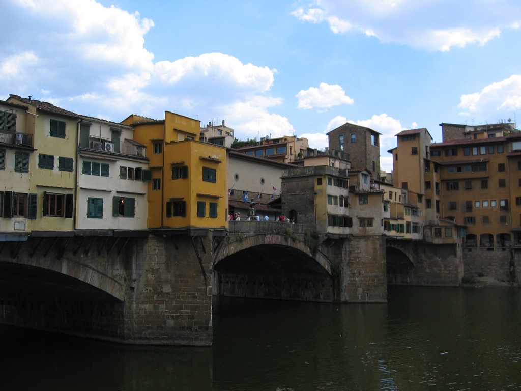 a bridge over a river with buildings under it