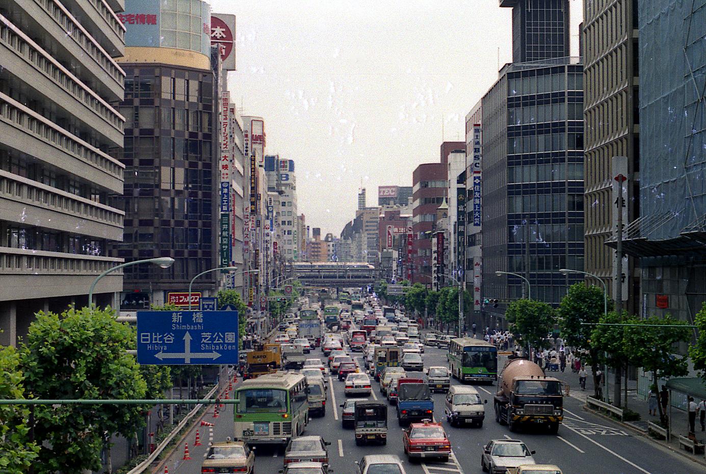 a street full of traffic driving down it