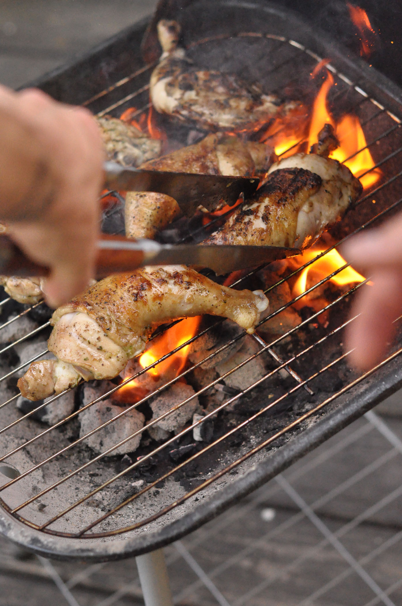 a person  meat on the grill with tongs