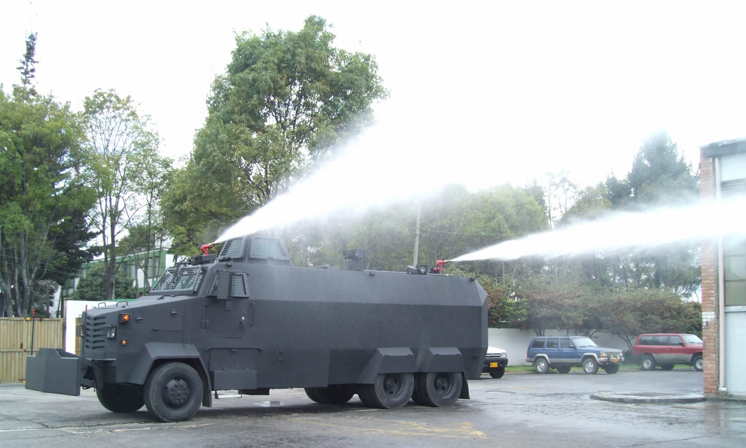 a gray army vehicle with water pouring out of the top