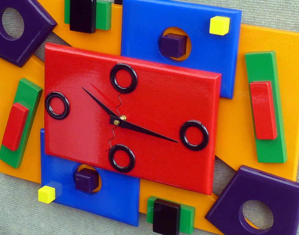 this is a multi colored clock in the shape of a cube