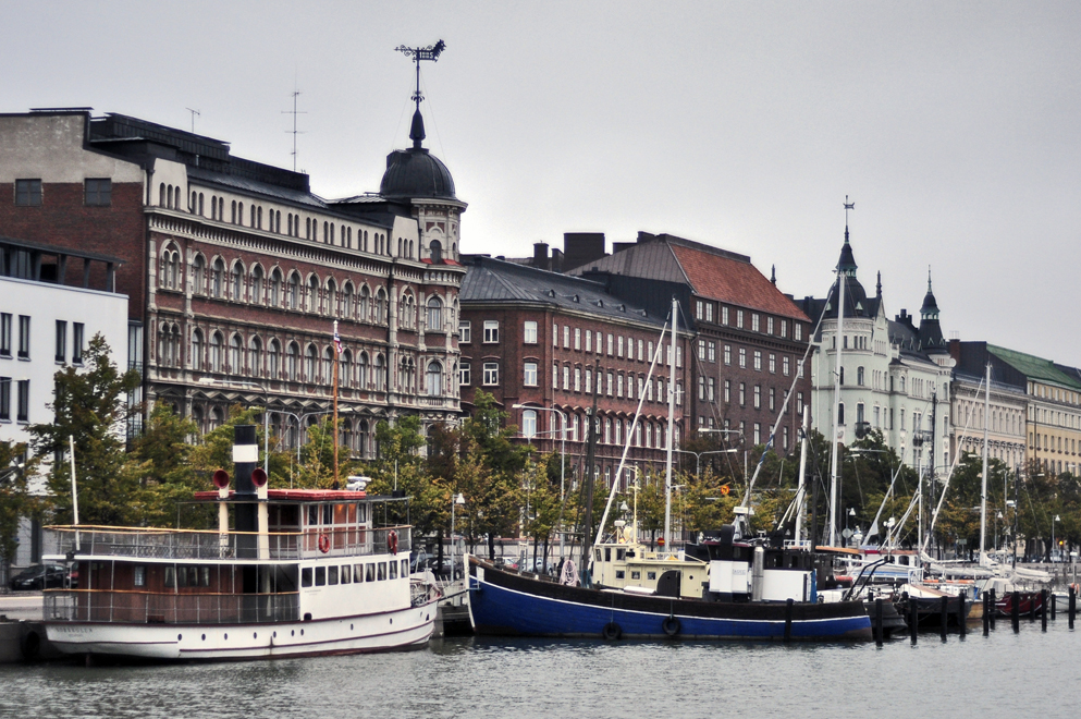 large buildings line the edge of a river