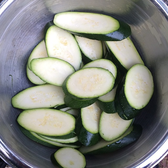 sliced zucchini in a metal bowl on the ground