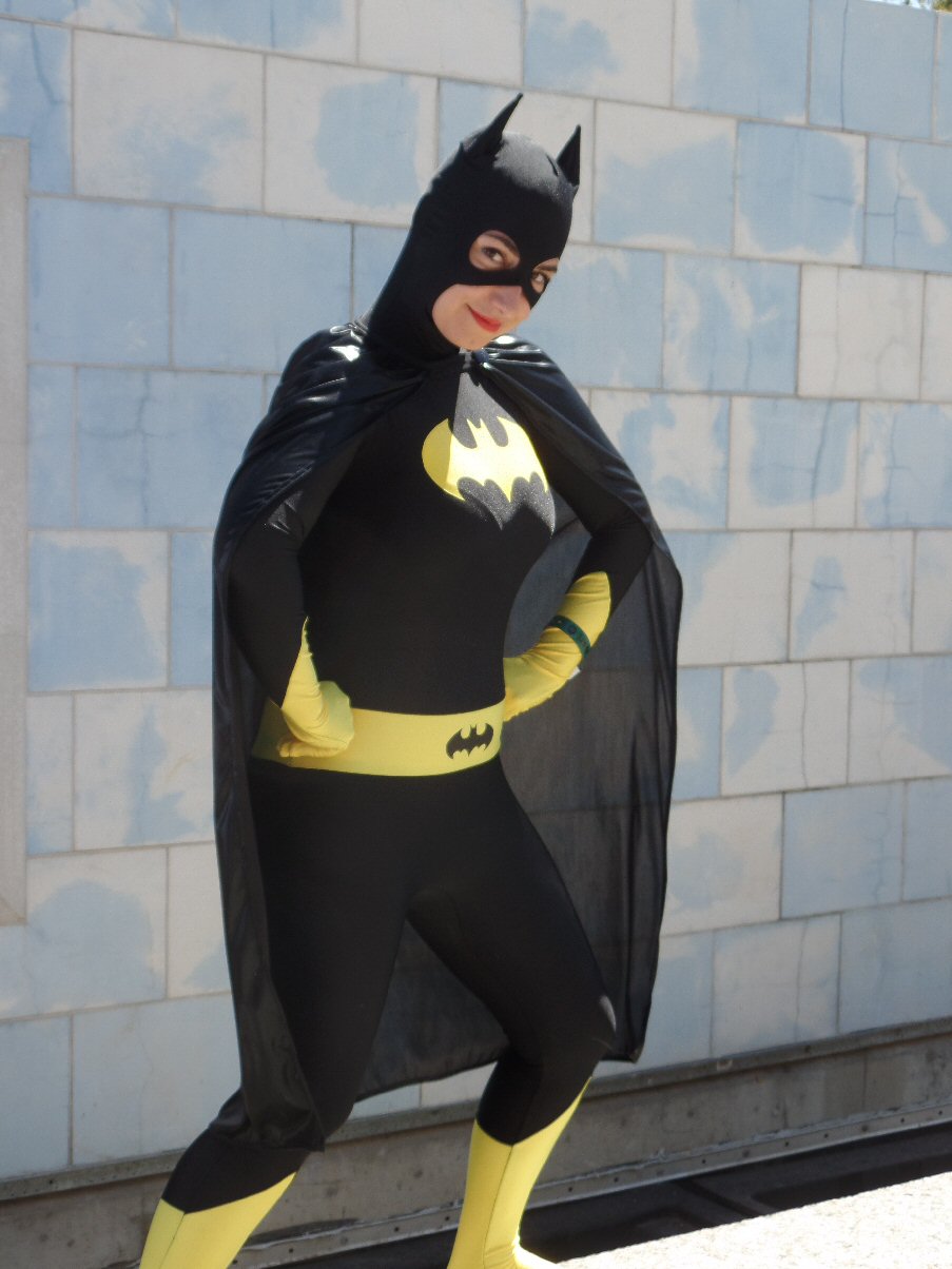 a man dressed in batman costume in front of a building