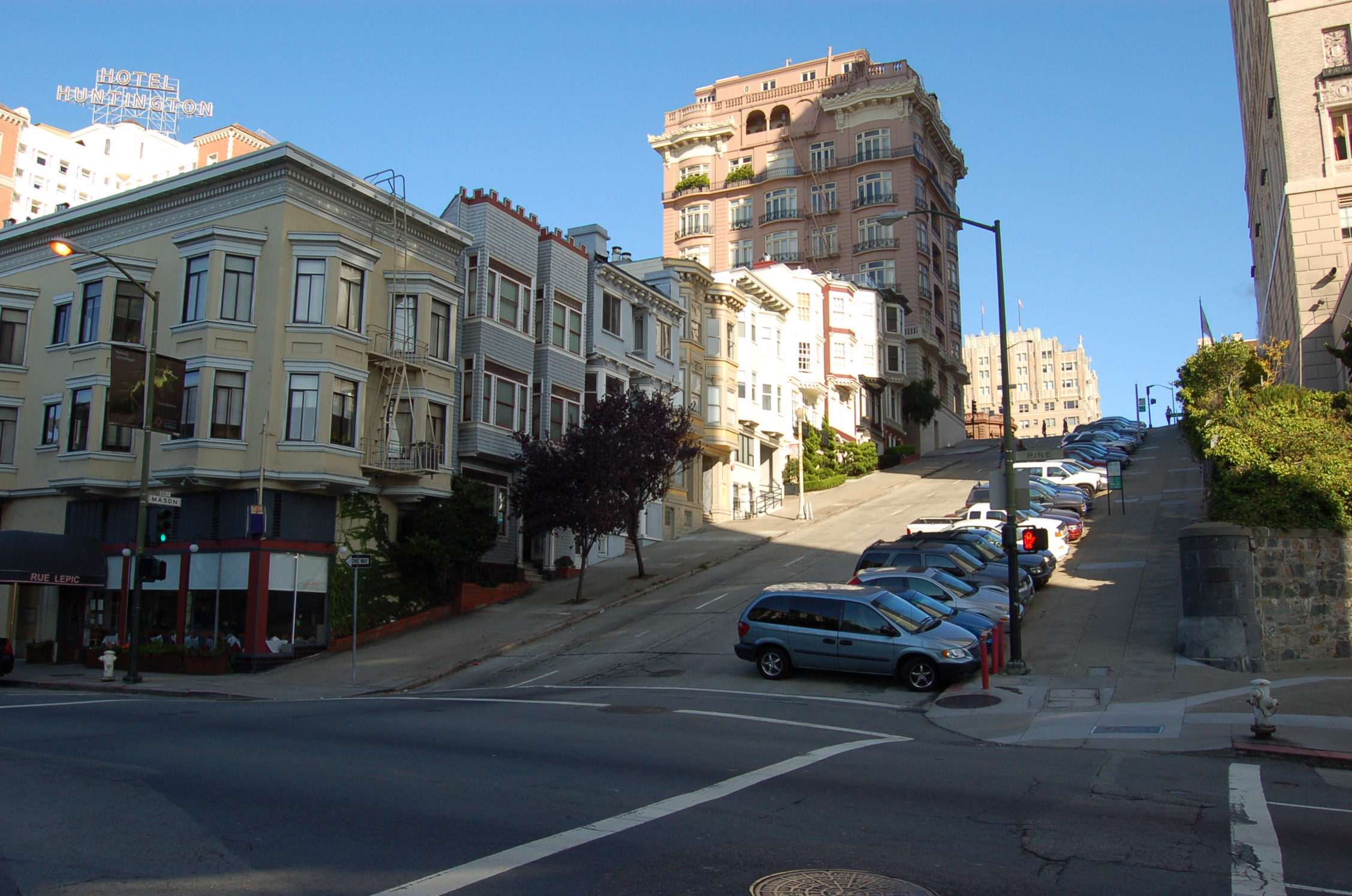 the street is lined with buildings, one large and one small