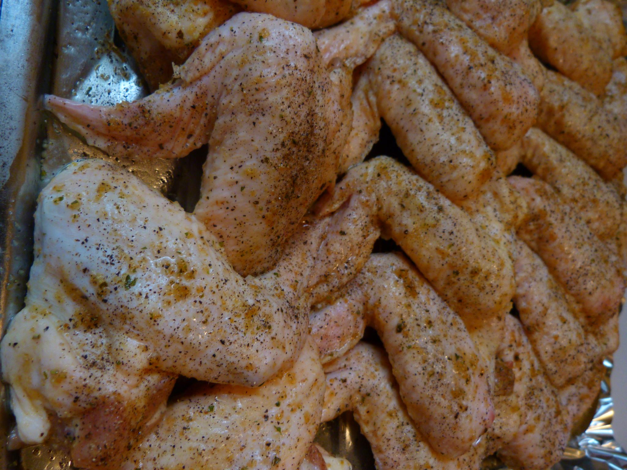 a silver pan with some raw chicken pieces on top of it