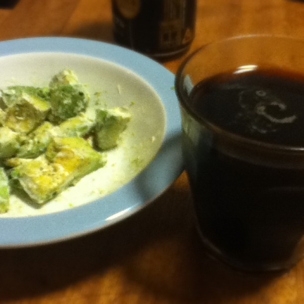 a plate of broccoli and a cup of black tea