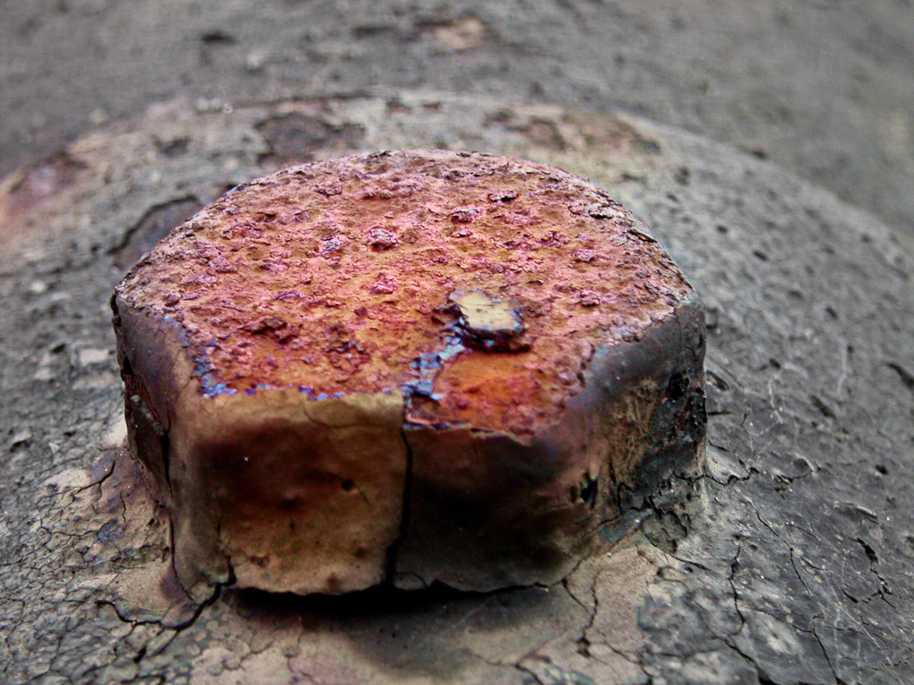 a piece of burnt red rock on the ground