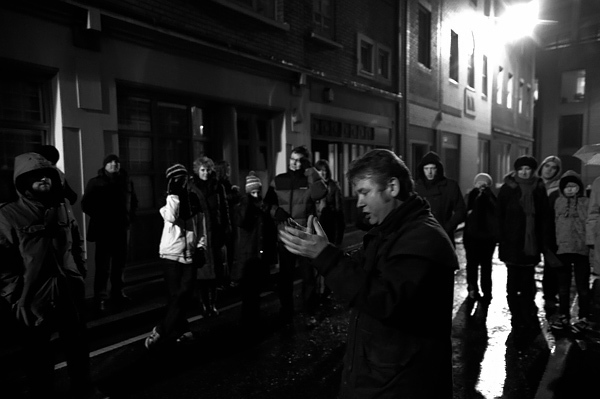 man using cell phone at city at night