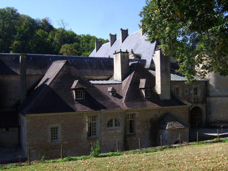 a castle style house with stone columns and a pointed roof