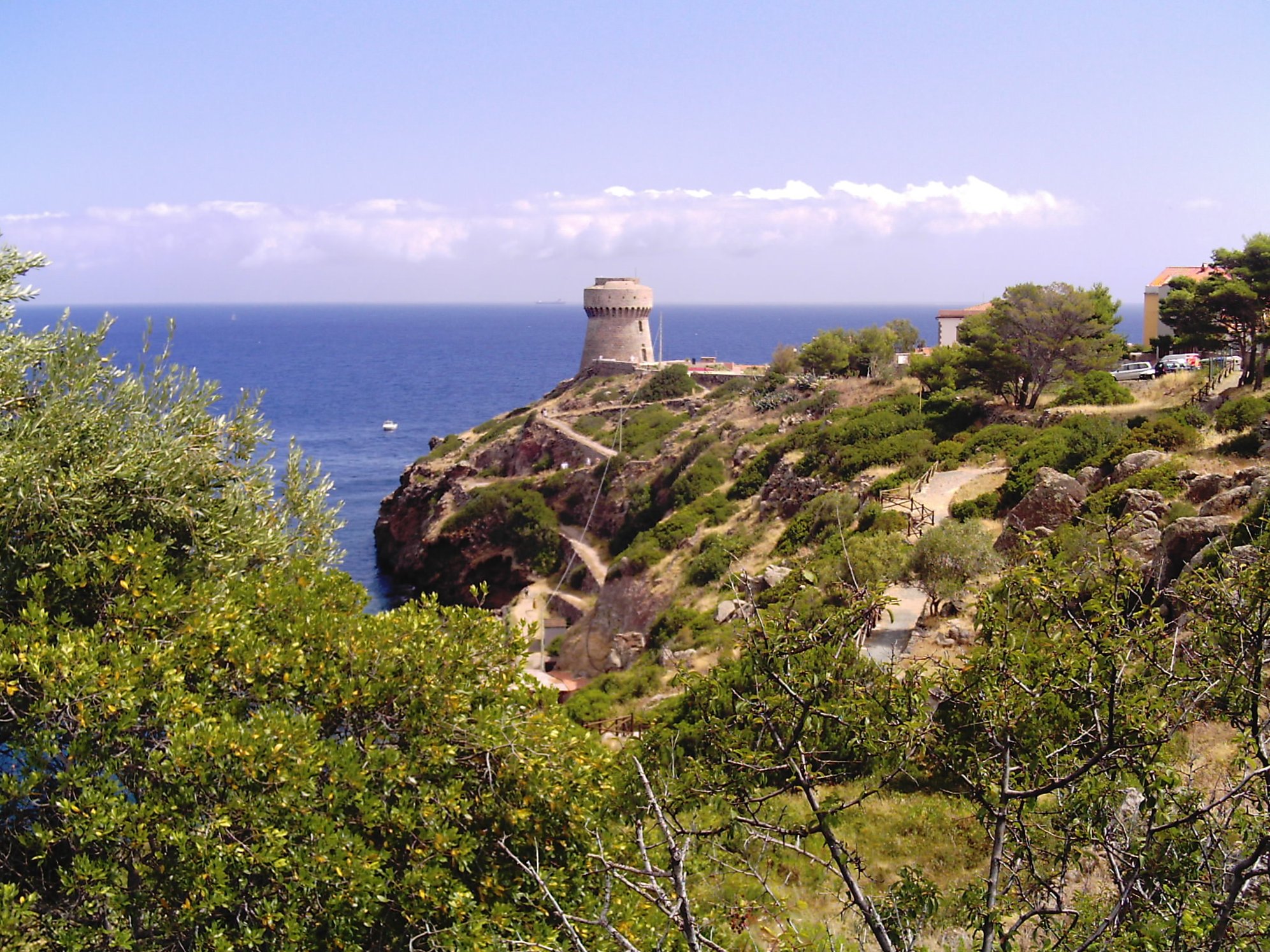 a small tower standing on top of a rocky hill