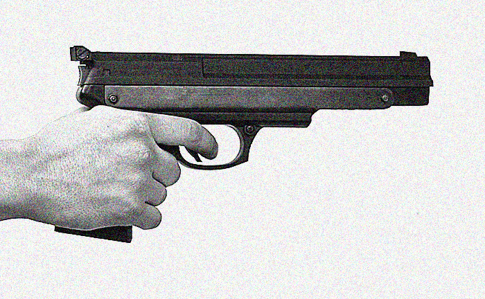 a hand holding a small revolver with a black body