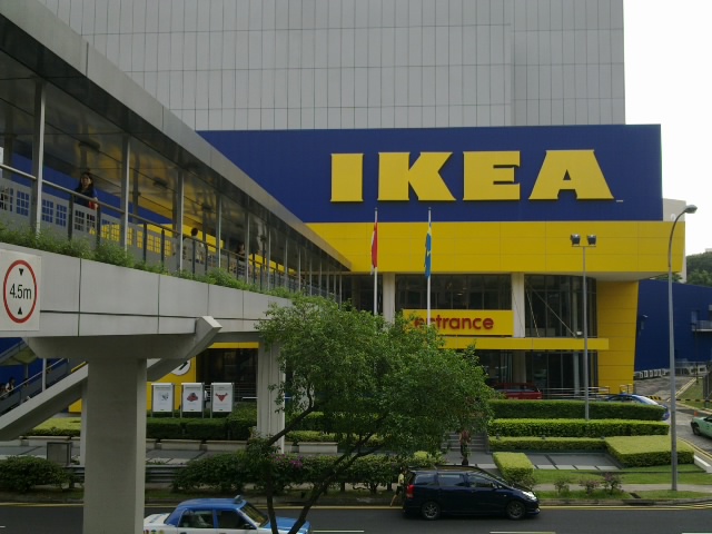 a large ikea store with cars parked outside it
