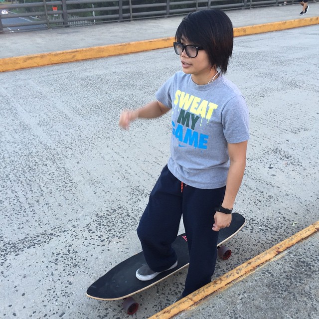 a little girl on a skateboard on the road