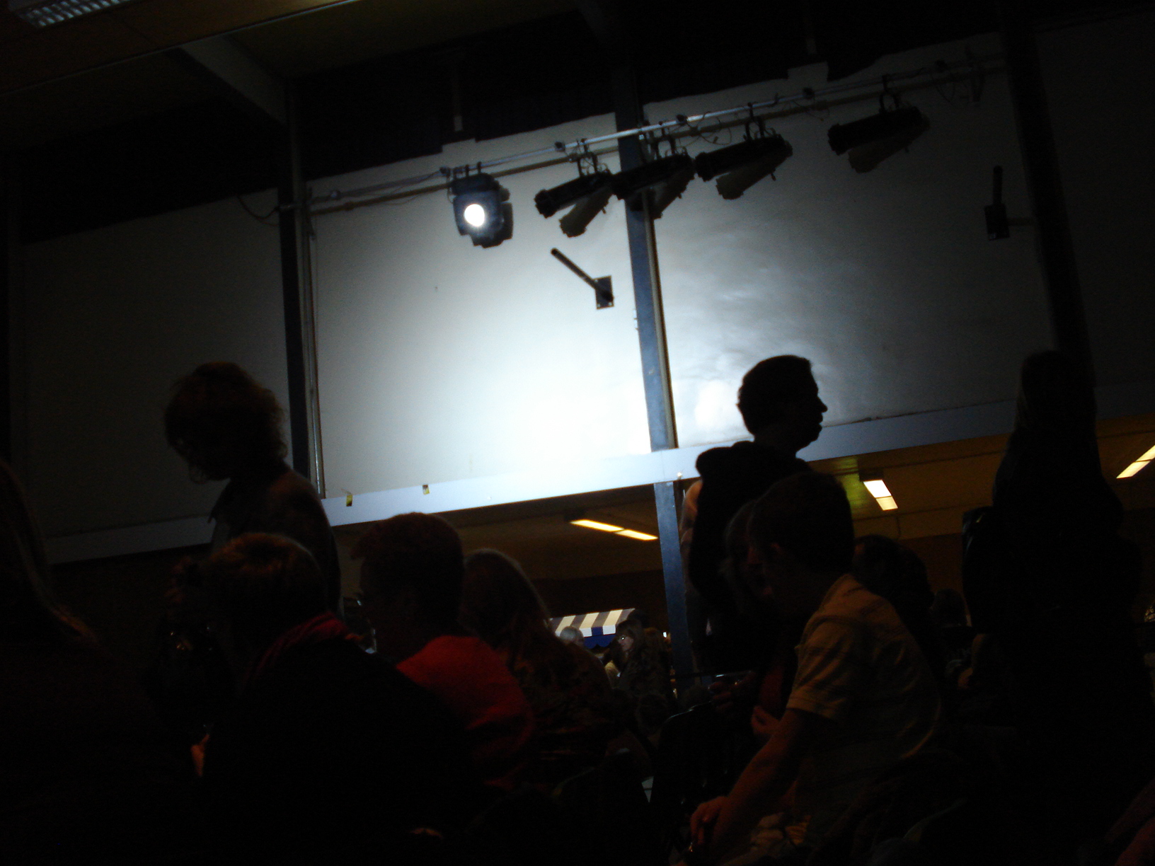 a group of people sitting around in front of a light