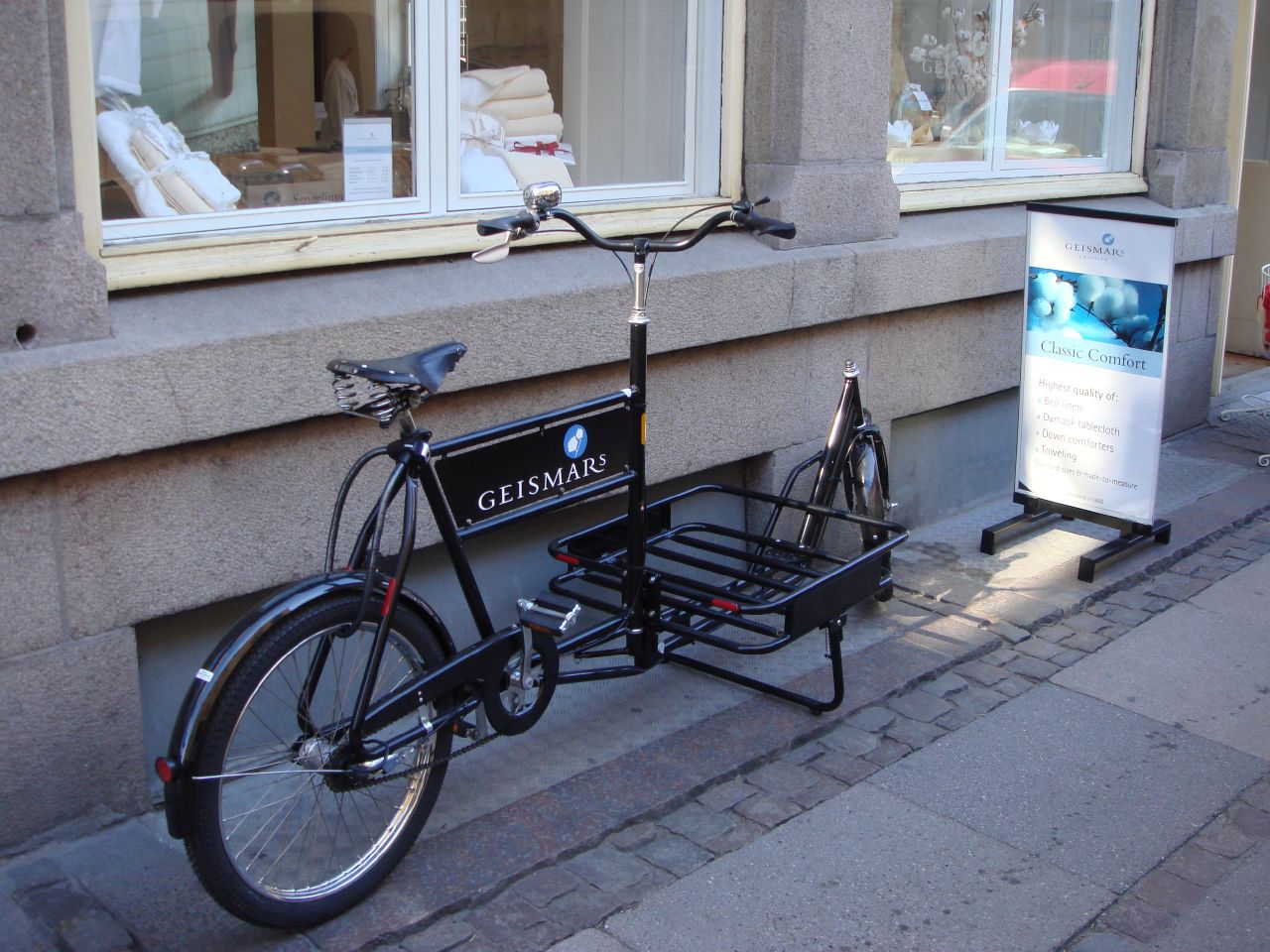 a bike parked next to a street sign