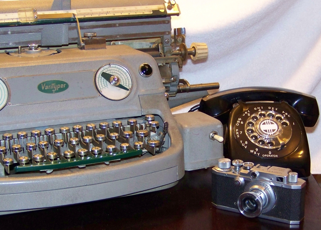 an antique typewriter sitting next to a camera