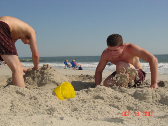 a man and boy in sandcastles near the beach