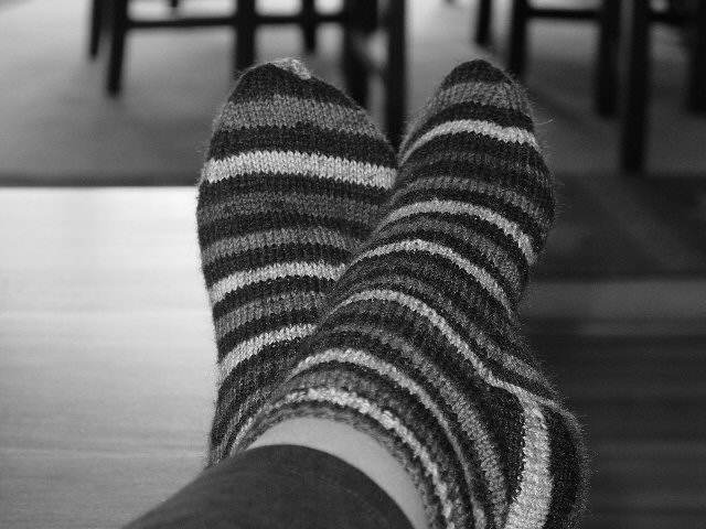 a person is in striped socks on top of their feet