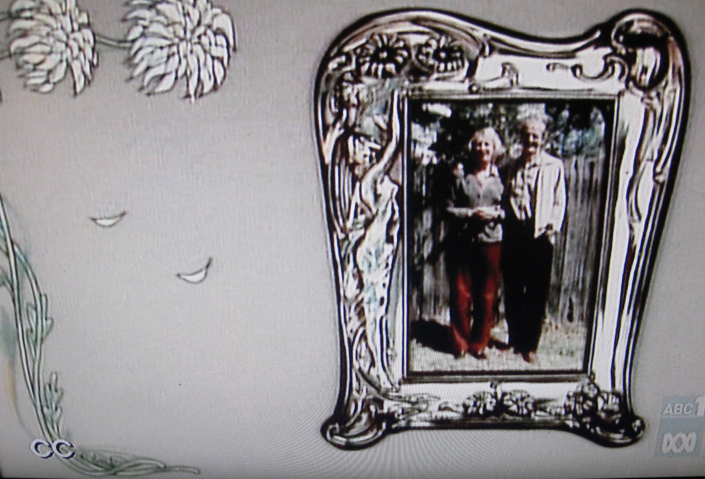 a television monitor screen with a picture of two ladies in a picture frame