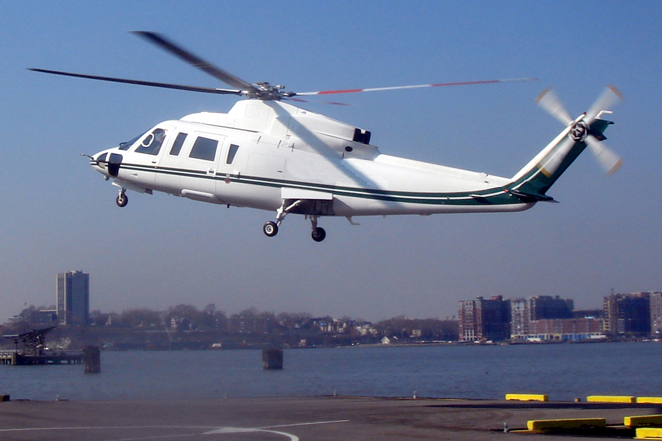 a large helicopter taking off from the runway