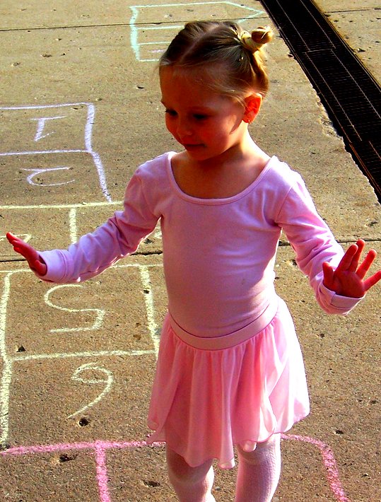 a small child standing on top of chalk chalk