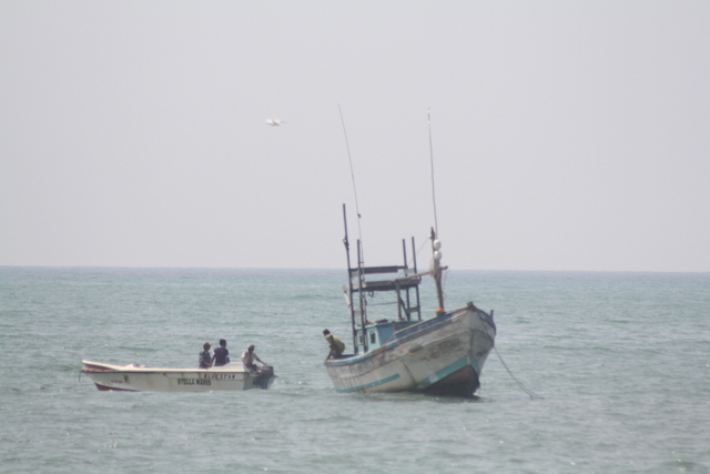 two small boats near each other in the ocean