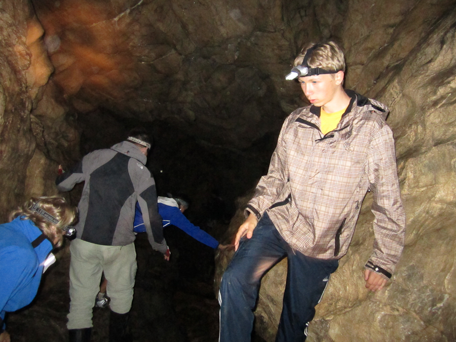 a group of people standing inside of a cave