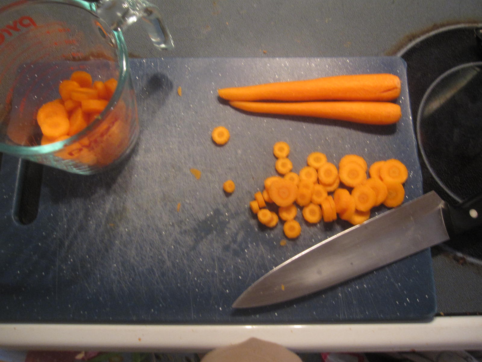 some carrots and other food laying on the  board