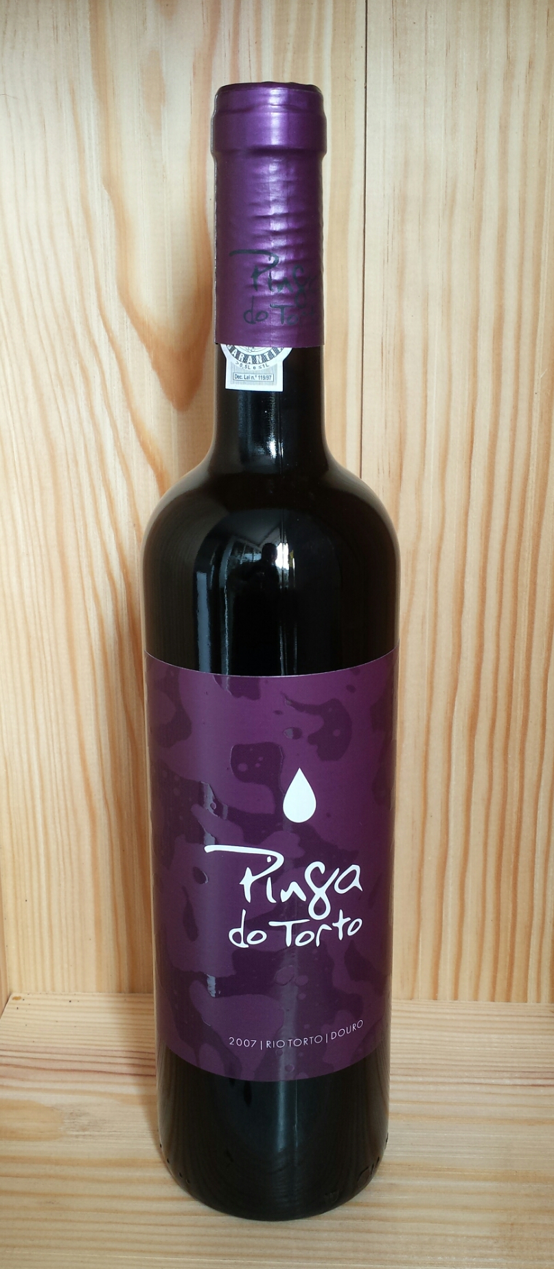 a bottle of wine with purple trim on the top