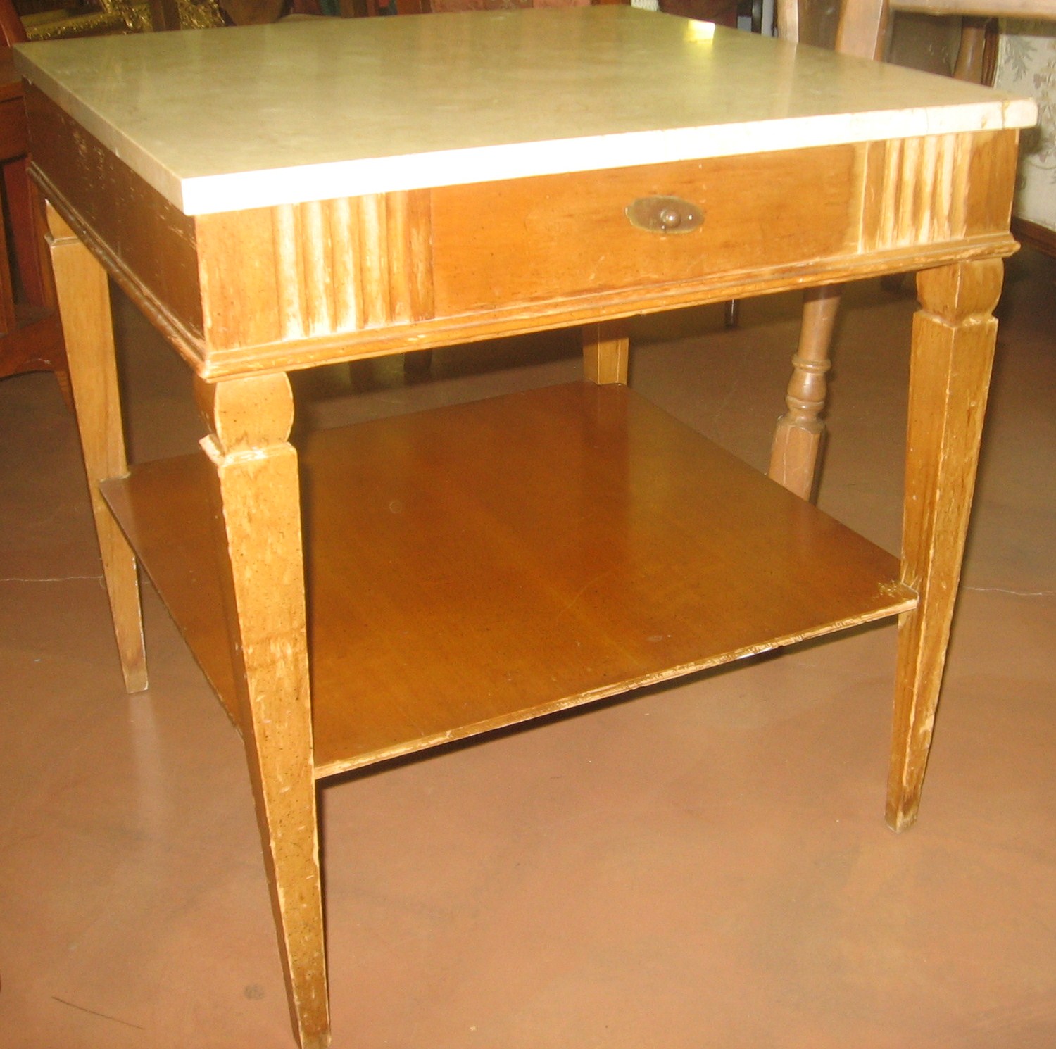 small wooden desk sitting on tiled flooring in a room