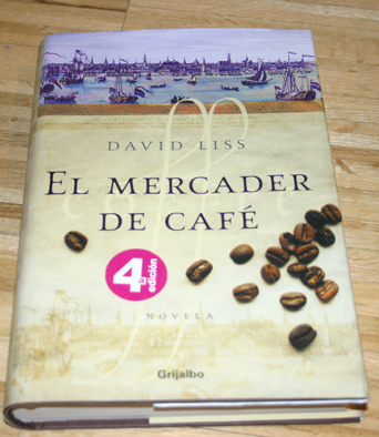 a book on a table with several coffee beans