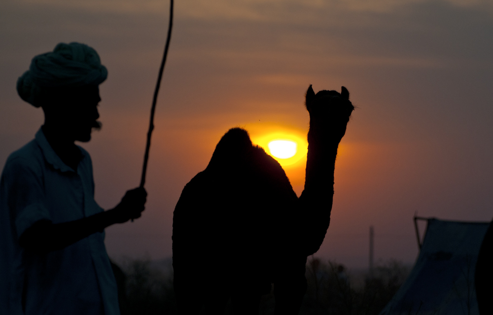 a man holding up a small stick near another person