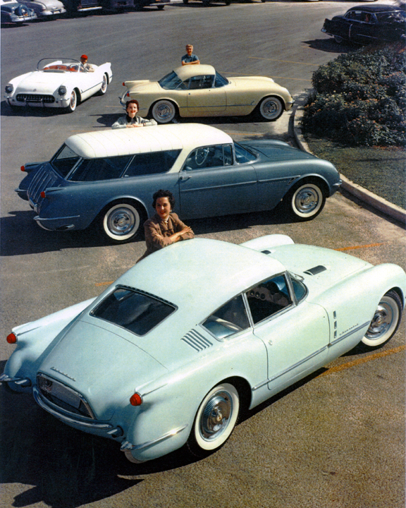 vintage automobiles are parked in a parking lot