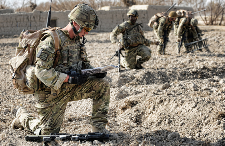 a group of soldiers that are standing in the dirt