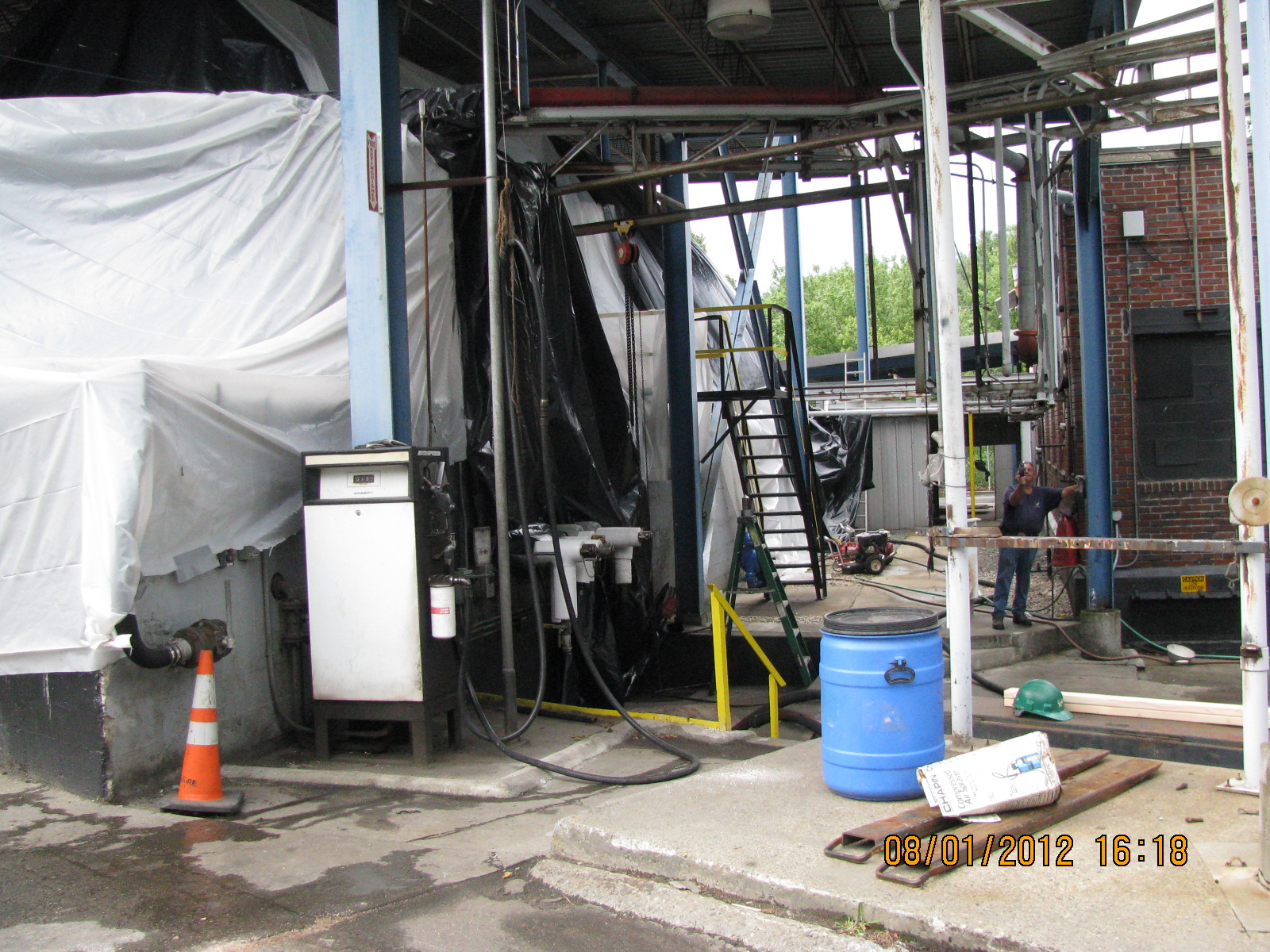 a warehouse with a few workers standing around