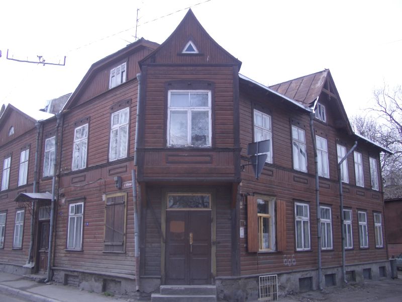 large brown wooden building with multiple windows and balconies