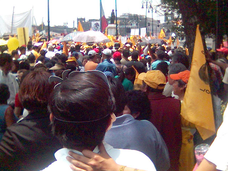 people in the street are gathered together, holding flags