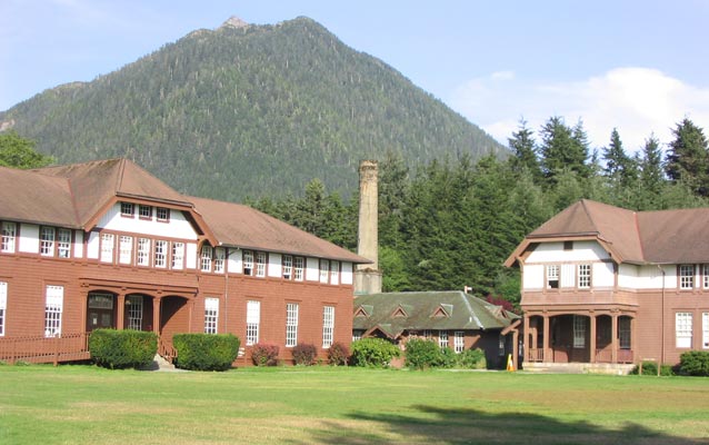 a view of the front of a large building and mountains