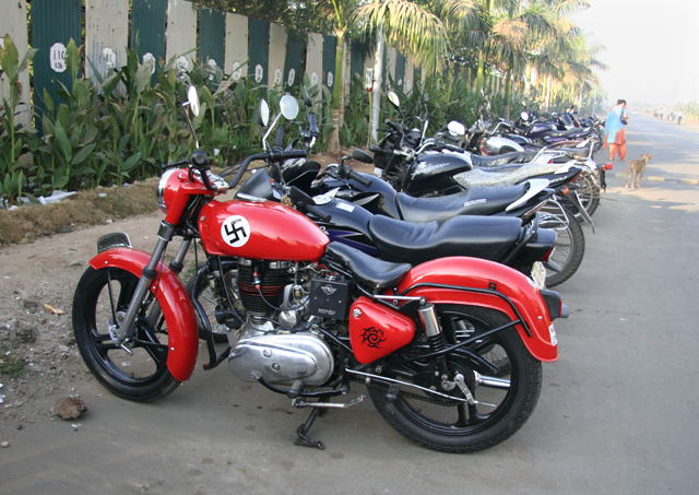 a line of red and black motorcycles parked on the street