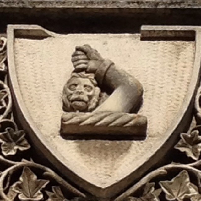 an old fashioned carving of a head on a plaque