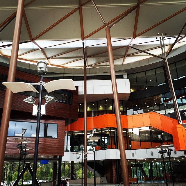 a circular atrium with multiple windows, an outdoor clock and sculptures