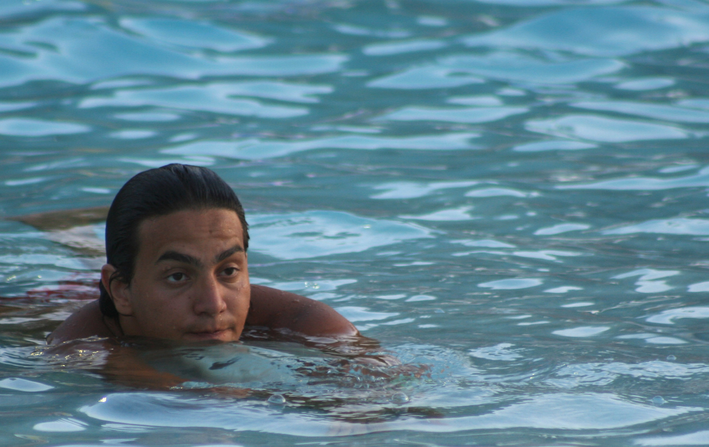 a man in the water has his face slightly submerged