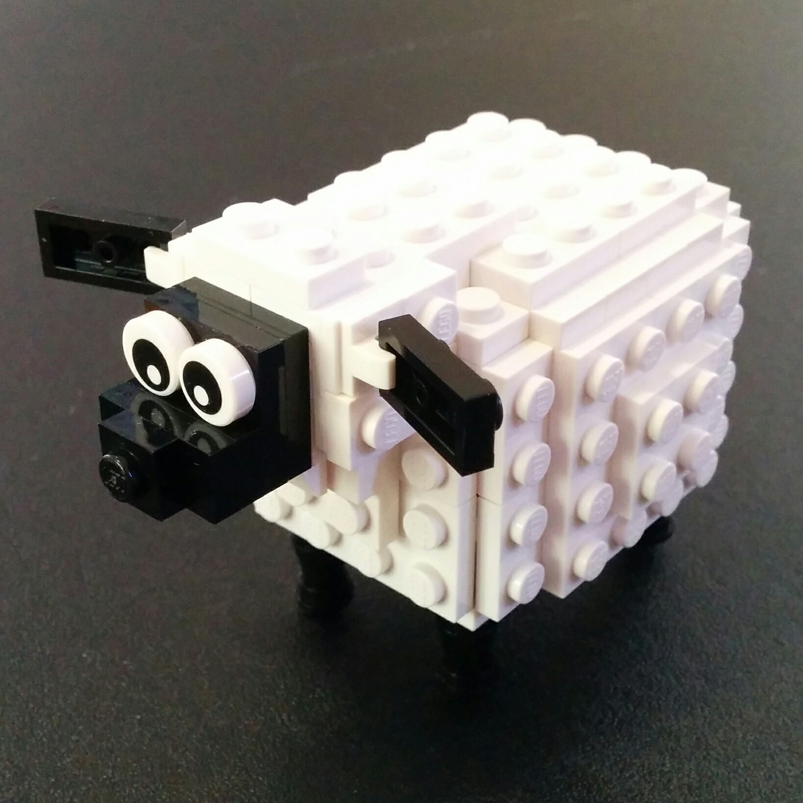 a sheep made of many small bricks on a table