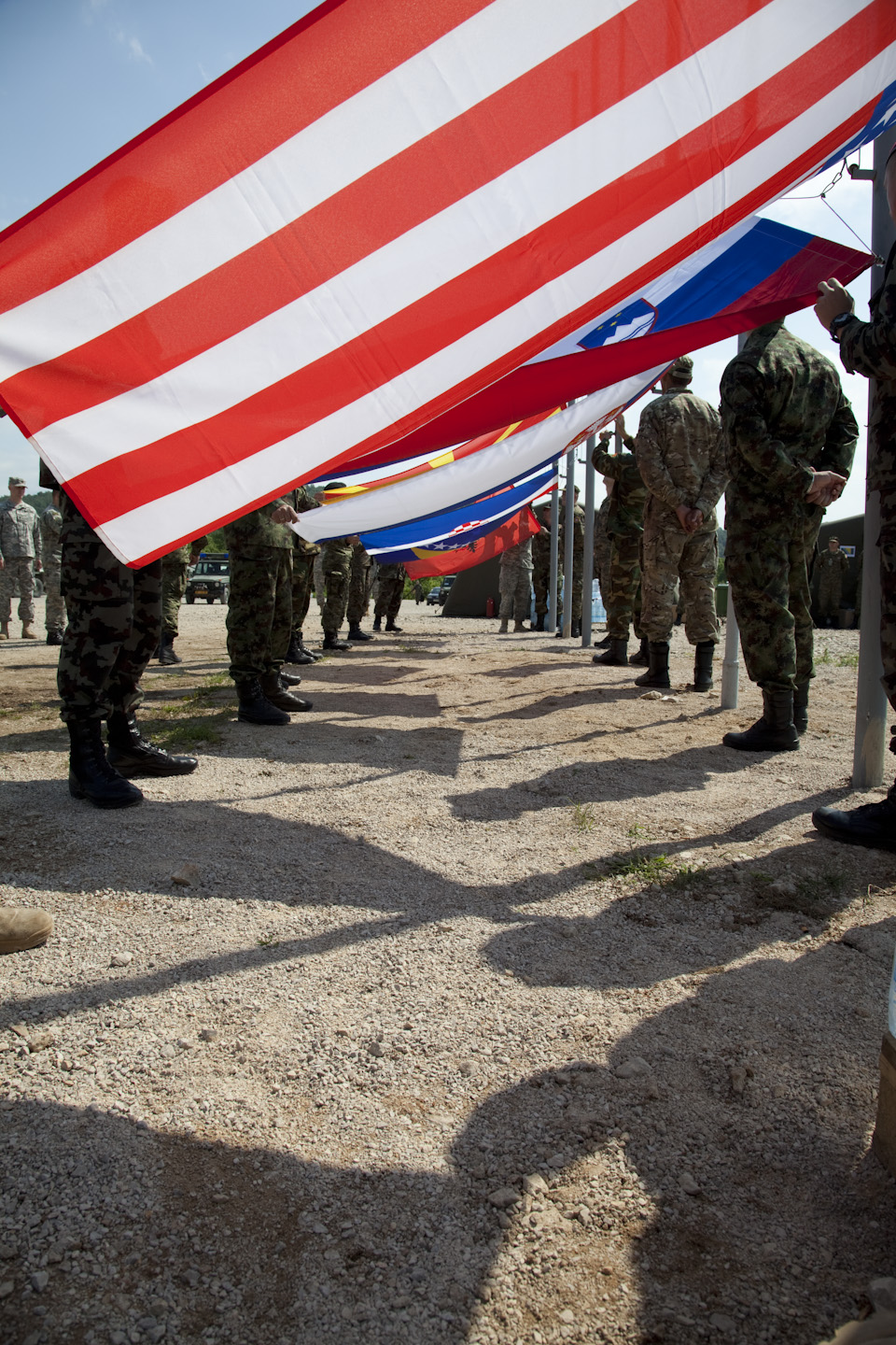 many people in the military uniform holding american flags