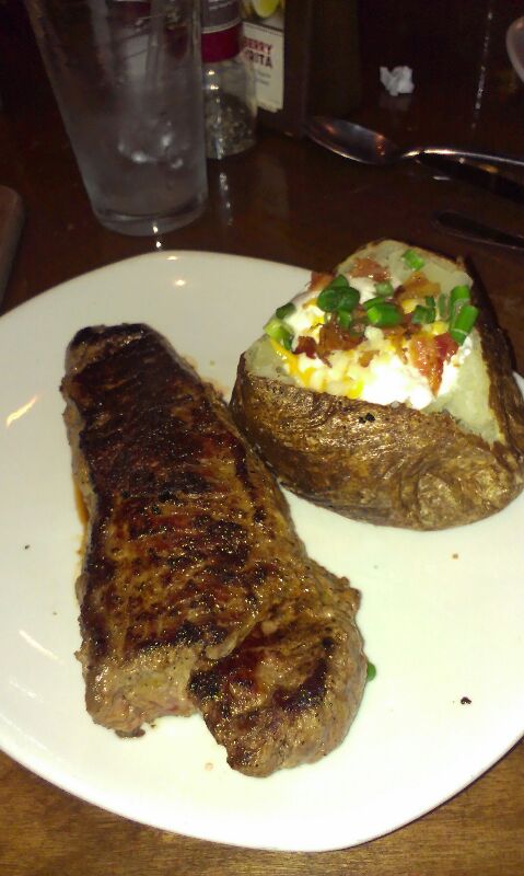 two steaks on a plate with potato