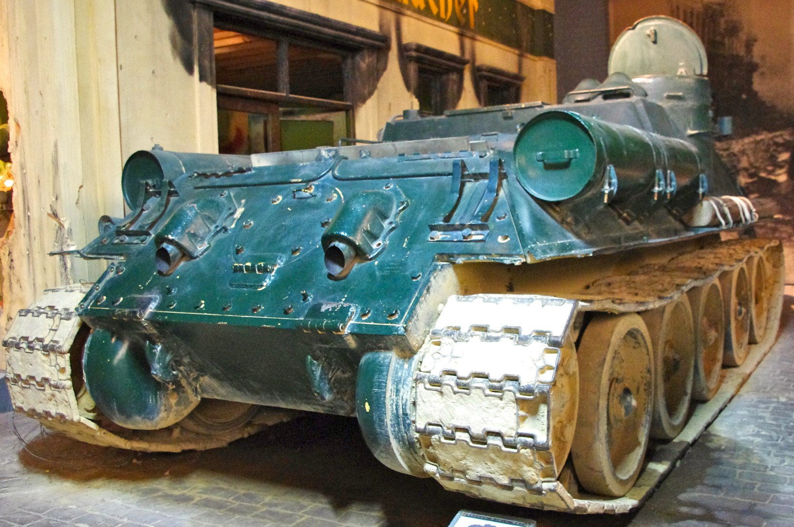 an old, worn out, and rusty tank is on display in a museum