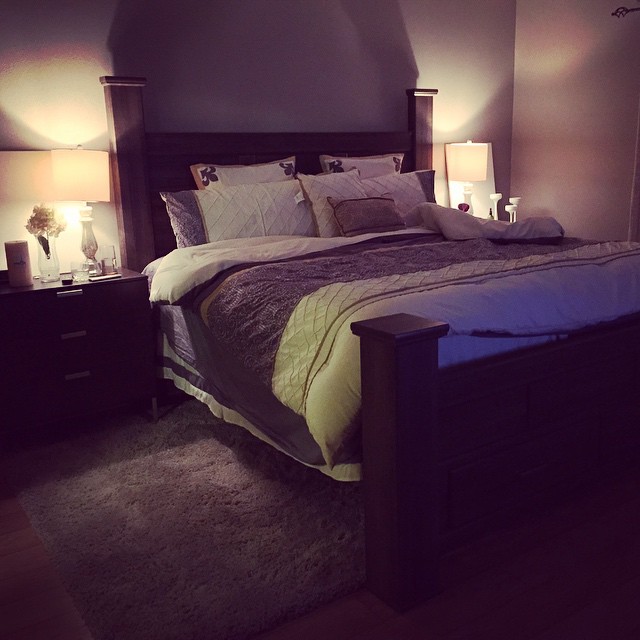 the bedroom has two lamps on either side and a bed