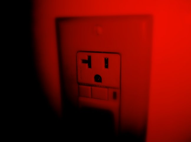 the electric plug is turned on in a dark room