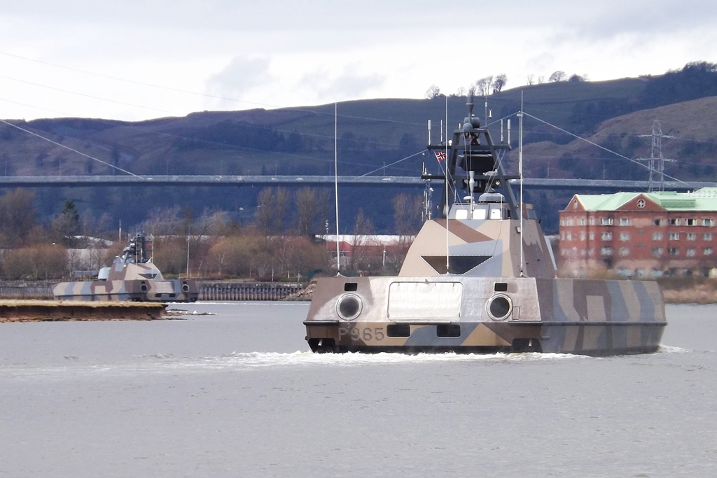 a boat in the water, under the bridge